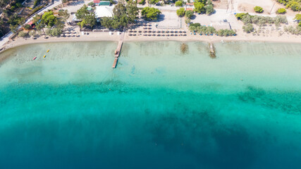 Fototapeta na wymiar Aerial view on turqouise blue water and sandy beach of Limni Vouliagmeni or Ireon Lake, Peloponnese, Greece 