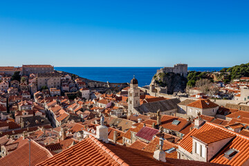 Colorful fortress street walk scene, clear sky sunny day. Beautiful building roofs. Scenery winter view of Mediterranean old city of Dubrovnik, famous European travel and historic destination, Croatia