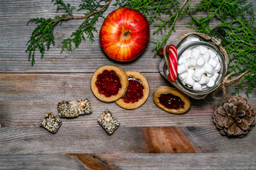 Marshmallows, cookies, lollipops and christmas decorations on a wooden table