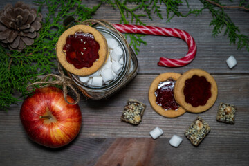 Marshmallows, cookies, lollipops and christmas decorations on a wooden table