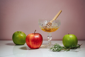 Jar of honey, apples and pomegranates on the table for the holiday of Rosh Hashanah