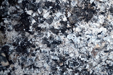 Coals in an extinct fire. Natural gray background. Coal and ash in a burnt fire