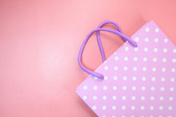 women gift bag on pink background top view.