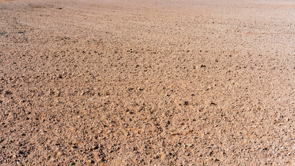 brown ground of agricultural farmland field with tillage soil for gardening