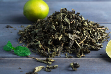 green tea and lime on the table, brew tea - obrazy, fototapety, plakaty