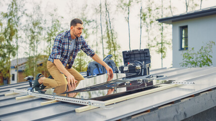 Caucasian Man in Checkered Shirt is Installing Black Reflective Solar Panels on a Metal Basis. He Works on a House Roof on a Sunny Day. Concept of Ecological Renewable Energy at Home.