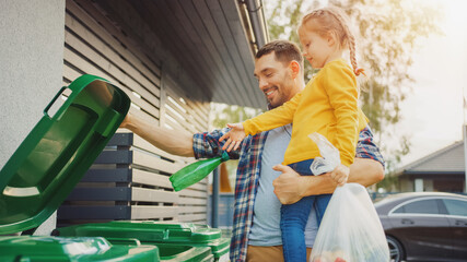 Father Holding a Young Girl and Throw Away an Empty Bottle and Food Waste into the Trash. They Use...
