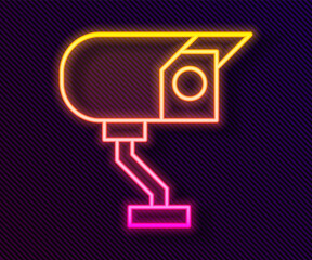 Glowing neon line Security camera icon isolated on black background. Vector.
