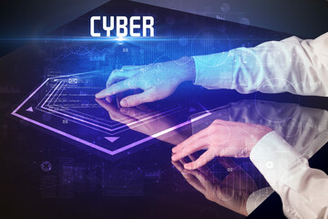 Hand touching digital table with CYBER inscription, new age security concept