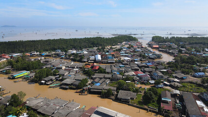 Obraz premium Aerial view of fisherman village, and river to the sea in Thailand