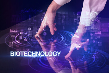 Businessman touching huge display with BIOTECHNOLOGY inscription, modern technology concept