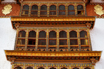 Fototapeta na wymiar Bhutan, city of Paro, wooden windows in the oldest temple of Bhutan, the Kyichu Lhakhang Temple. 