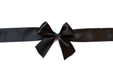 Black ribbon with bow isolated on white background.