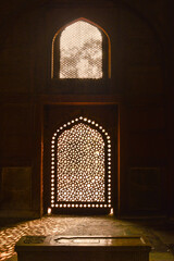 Sun rays create dramatic light and shadow inside of the humayun tomb memorial at winter foggy...