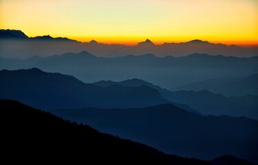 Obraz premium Sunrise with some of the Highest Peaks (Mt. Nanda Devi, Mt. Dronagiri and Mt. Trishul) situated in the Uttarakhand state of India. Picture clicked from Churdhar, Sirmour, Himachal Pradesh, India
