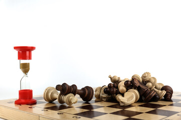 hourglass and dead chess pieces on white background