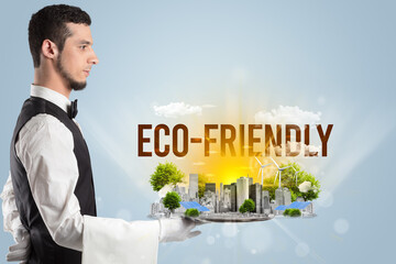 Waiter serving eco city with ECO-FRIENDLY inscription, renewabke energy concept