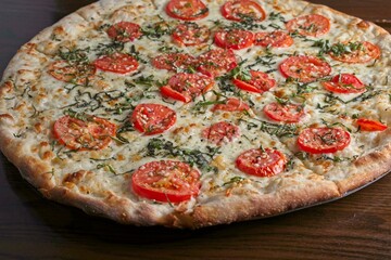 Gourmet pizza white pie with sliced Roma tomato & fresh basil