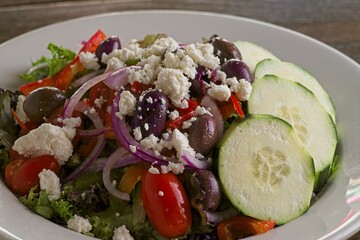 Gourmet Greek salad with mixed greens with romaine, feta, Kalamata olive, cucumber, tomato, bell pepper & red onion. Served with Greek vinaigrette