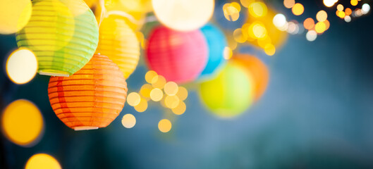 Festive background with colorful lights garland and bright bokeh. Holiday light decor. Celebration...