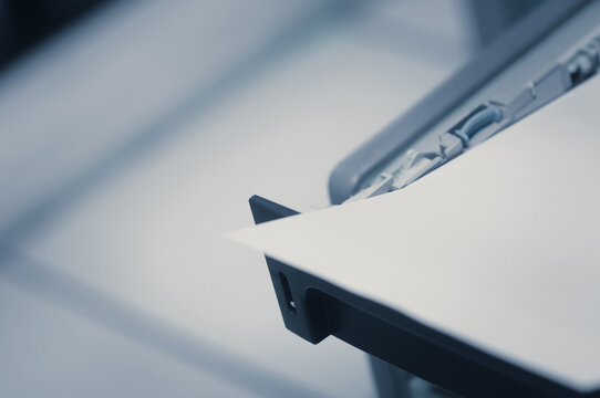 Printer and paper in office. Selective focus