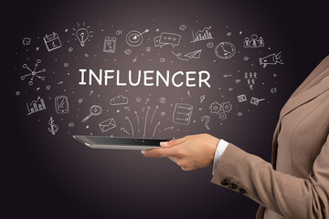 Close-up of a touchscreen with INFLUENCER inscription, social media concept