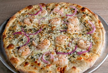 Gourmet pizza white pie with shrimp, red onion, caper & lemon.