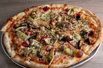 Gourmet pizza with Artichoke, sun-dried tomato & eggplant on thin crust.