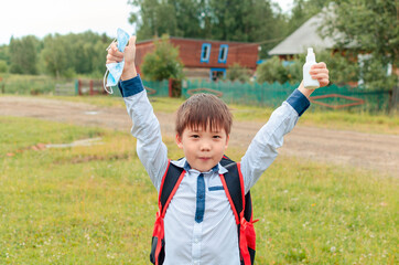 Asian child boy student in school uniform medical face mask and sanitizer back to school epidemic...