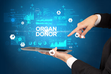 Close-up of a touchscreen with ORGAN DONOR inscription, medical concept