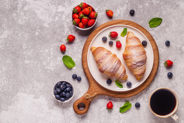 Obraz na płótnie Canvas Breakfast with croissants and fresh fruits.