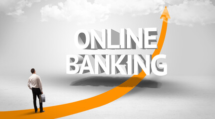 Rear view of a businessman standing in front of ONLINE BANKING inscription, successful business concept