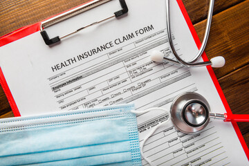 Health insurance form with stethoscope and surgical mask,