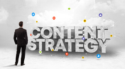 Young businessman standing in front of CONTENT STRATEGY inscription, social media concept