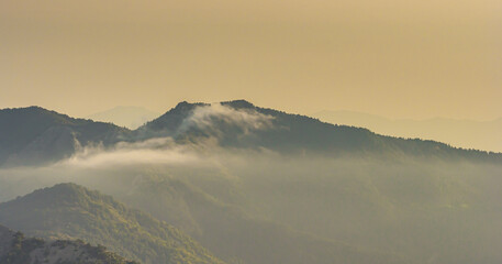 The settling mist reveals the mountain peaks showing us how beautiful and powerful they are.