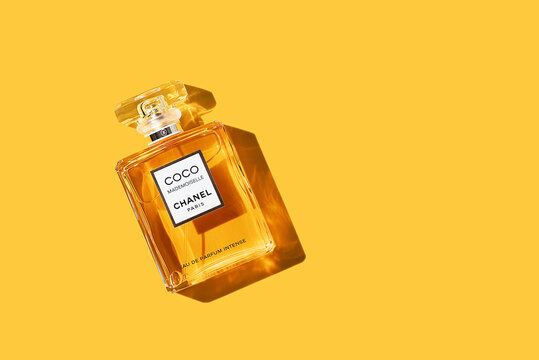 A bottle of Chanel perfume on a uniform yellow background, with a beautiful shadow with highlights. Coco Chanel woman perfume series. 2020-07-05 Samara.