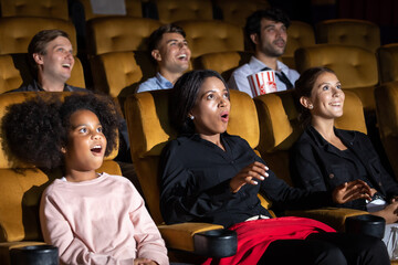 Group of diversity people watching movie in cinema theater with popcorn and drinks. Enjoy Happy laughing fun sad drama action movie concept.
