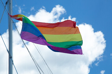 a rainbow pride flag waving in a breeze