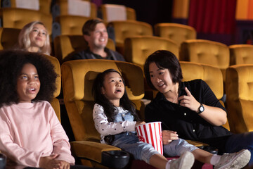 Happy family watching movie in cinema theatre. Happy family time in holiday