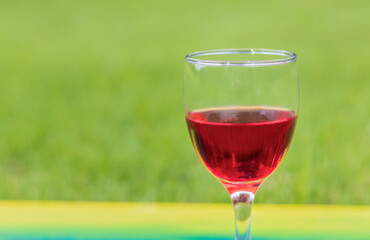 Red wine glass on natural background