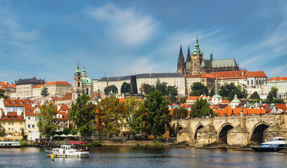 Fototapeta na wymiar Prague city architecture, seasides blue sky, and boats.