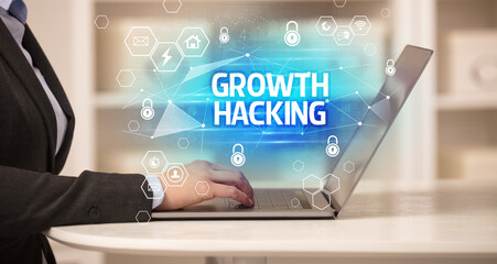 GROWTH HACKING inscription on laptop, internet security and data protection concept, blockchain and cybersecurity