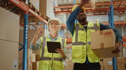 Retail Warehouse full of Shelves with Goods in Cardboard Boxes, Male and Female Supervisors Use Digital Tablet Discuss Product Delivery while Scanning Packages.Forklift Working in Logistics Storehouse