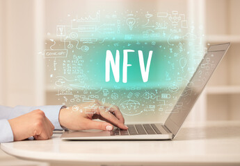 hand working on new modern computer with NFV abbreviation, modern technology concept