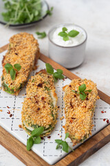 Baked zucchini with mozzarella cheese and spices.