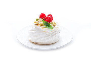 dessert Anna Pavlova with raspberries and cream on a saucer