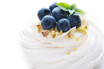dessert Anna Pavlova with blueberries and cream  isolated on a white background