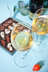 Champagne or wine in glasses and box of chocolates