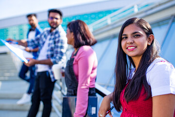 indian students keeping distance and do home work outdoors