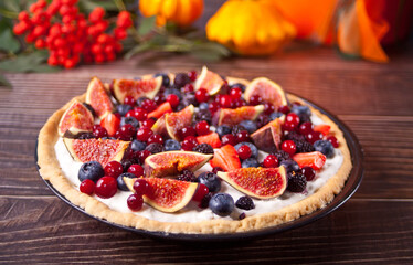 Fresh baked homemade fig and berries tart with mascarpone cheese